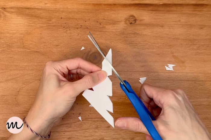 how to make a paper snowflake step 9 cut tip of triangle